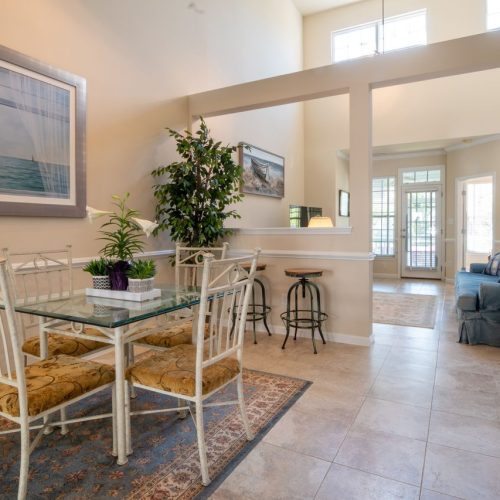 Modern and inviting open-concept dining and living area with natural light and elegant decor.